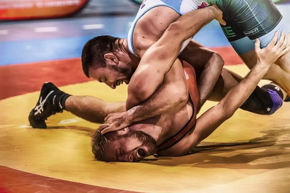 One man pressing anothers face in the ground